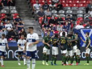Portland Timbers players celebrate after a Vancouver Whitecaps own goal during the second half of an MLS soccer match Friday, Sept. 10, 2021, in Vancouver, British Columbia.