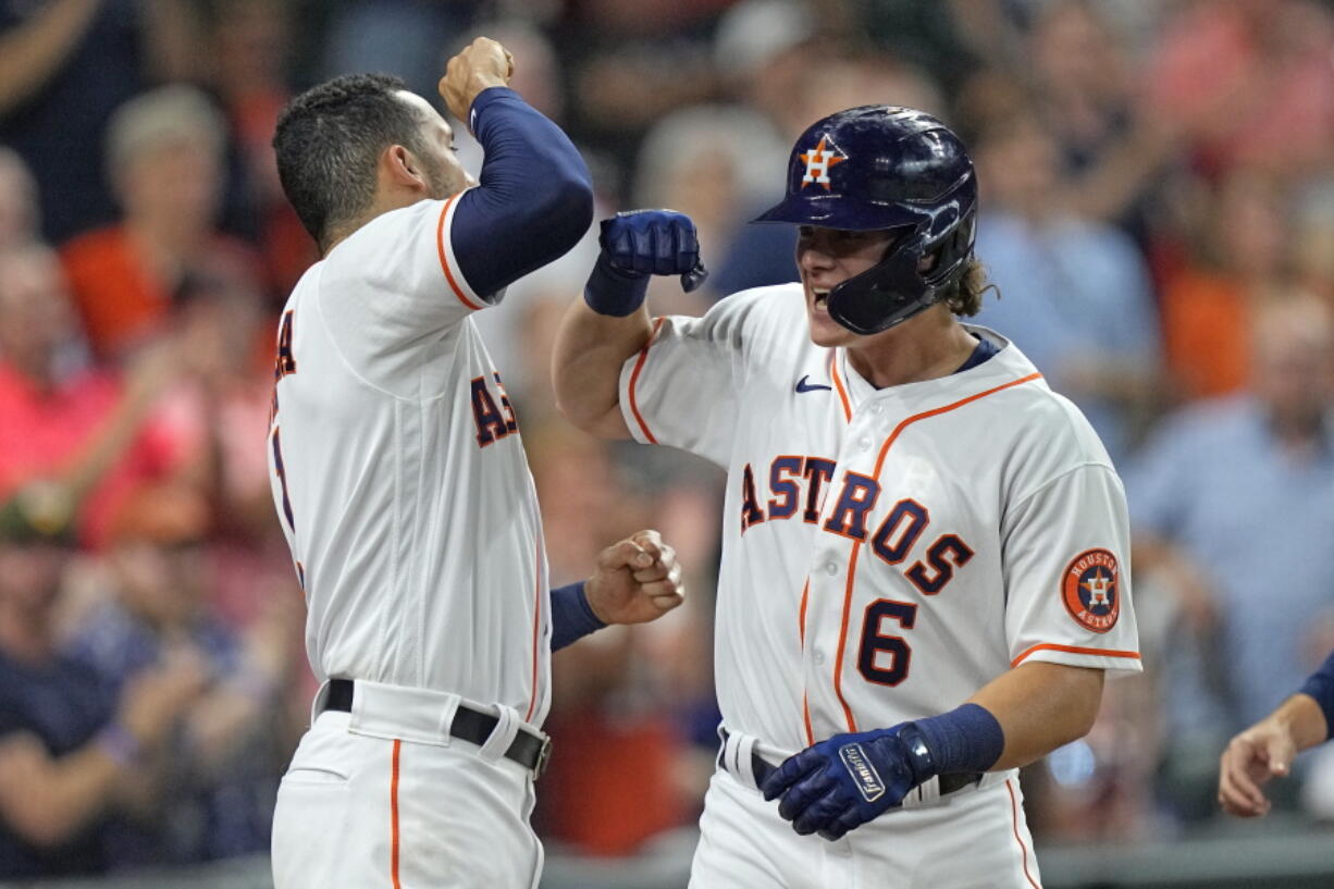 Houston Astros' Jake Meyers (6) celebrates with Carlos Correa after hitting a three-run home run against the Seattle Mariners during the second inning of a baseball game Monday, Sept. 6, 2021, in Houston. (AP Photo/David J.