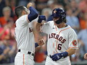 Houston Astros' Jake Meyers (6) celebrates with Carlos Correa after hitting a three-run home run against the Seattle Mariners during the second inning of a baseball game Monday, Sept. 6, 2021, in Houston. (AP Photo/David J.