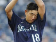 Seattle Mariners pitcher Yusei Kikuchi wipes sweat from his brow during the first inning of a baseball game against the Kansas City Royals at Kauffman Stadium in Kansas City, Mo., Saturday, Sept. 18, 2021. (AP Photo/Colin E.