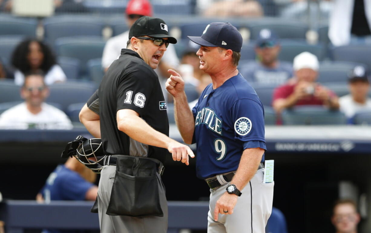 Seattle Mariners manager Scott Servais (9) argues with umpire Lance Barrett (16) before being ejected during the eighth inning of a baseball game against the New York Yankees, Sunday, Aug. 8, 2021, in New York. (AP Photo/Noah K.