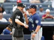 Seattle Mariners manager Scott Servais (9) argues with umpire Lance Barrett (16) before being ejected during the eighth inning of a baseball game against the New York Yankees, Sunday, Aug. 8, 2021, in New York. (AP Photo/Noah K.