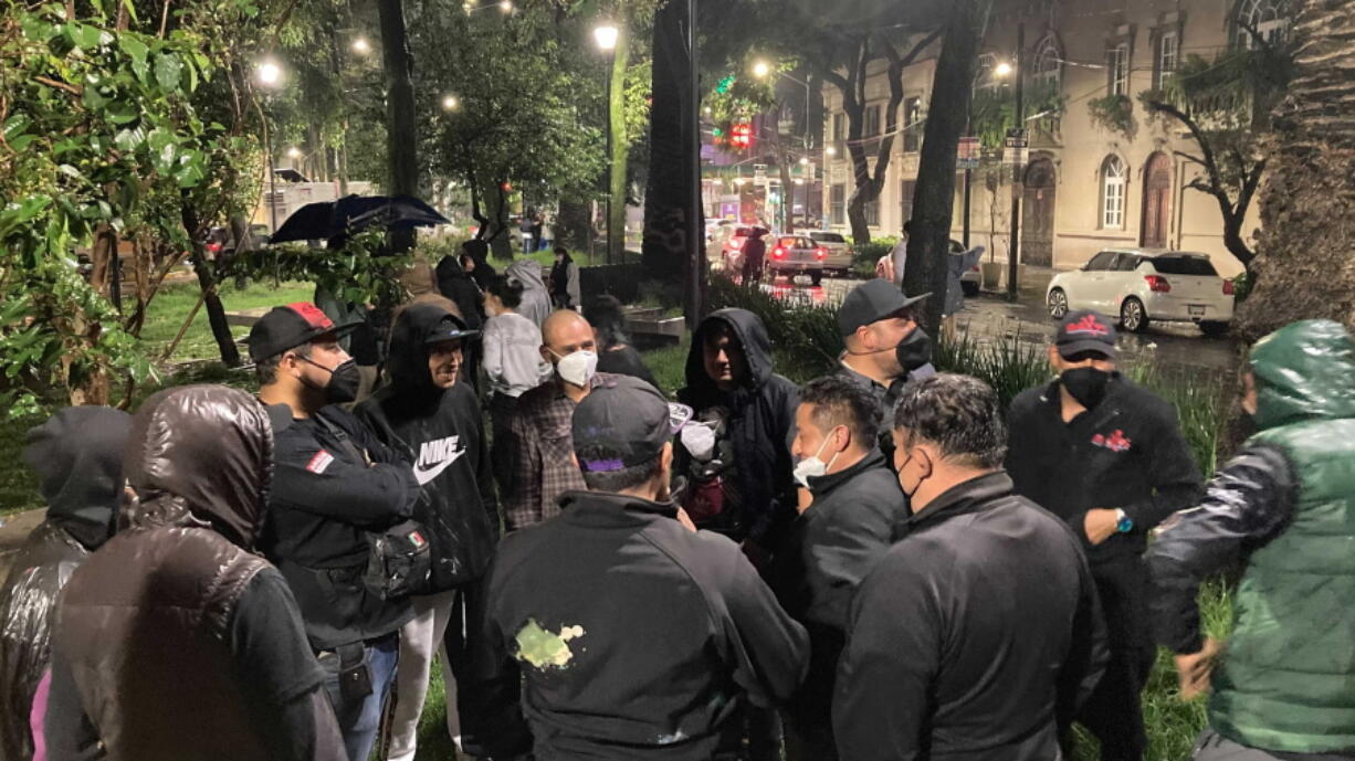 People gather outside on the sidewalk after a strong earthquake was felt, in the Roma neighborhood of Mexico City, Tuesday, Sept. 7, 2021. The quake struck southern Mexico near the resort of Acapulco, causing buildings to rock and sway in Mexico City nearly 200 miles away.