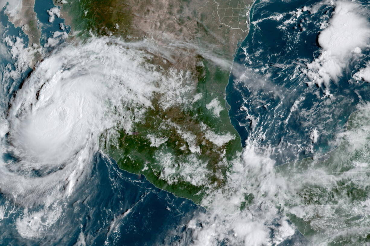 This satellite image provided by the National Oceanic and Atmospheric Administration shows Hurricane Olaf on the Pacific coast of Mexico approaching the Los Cabos resort region at the tip of the Baja California Peninsula, Thursday, Sept. 9, 2021, at 14:30 OZ (10:30am a.m. ET).