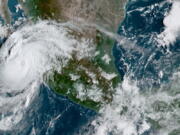 This satellite image provided by the National Oceanic and Atmospheric Administration shows Hurricane Olaf on the Pacific coast of Mexico approaching the Los Cabos resort region at the tip of the Baja California Peninsula, Thursday, Sept. 9, 2021, at 14:30 OZ (10:30am a.m. ET).