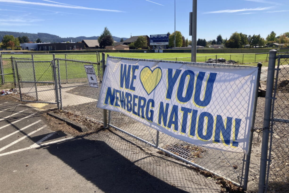 FILE - In this Sept. 21, 2021 file photo a banner thanking supporters of Newberg schools is seen next to the athletic fields of Newberg High School, in Newberg, Ore. The Newberg School Board, which last month banned educators from displaying Black Lives Matter and gay pride symbols, has broadened the policy to prohibit district employees from displaying all types of political symbols or those deemed controversial.