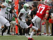 Oregon running back CJ Verdell, center, scores a touchdown against Ohio State during the first half of an NCAA college football game Saturday, Sept. 11, 2021, in Columbus, Ohio.