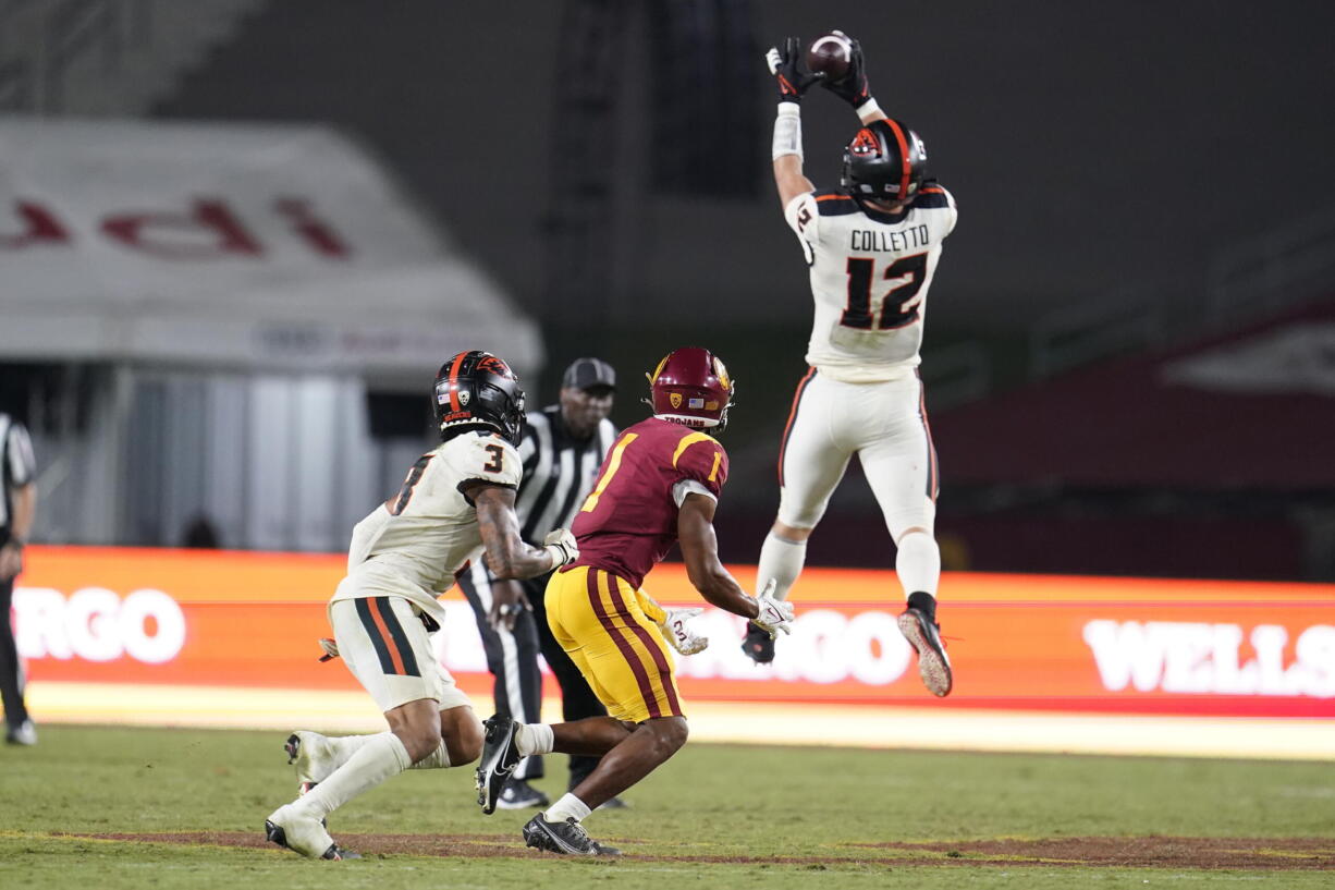 Oregon State linebacker Jack Colletto (12) jumps in front of Southern California wide receiver Gary Bryant Jr. (1) to intercept a pass during the second half of an NCAA college football game Saturday, Sept. 25, 2021, in Los Angeles.