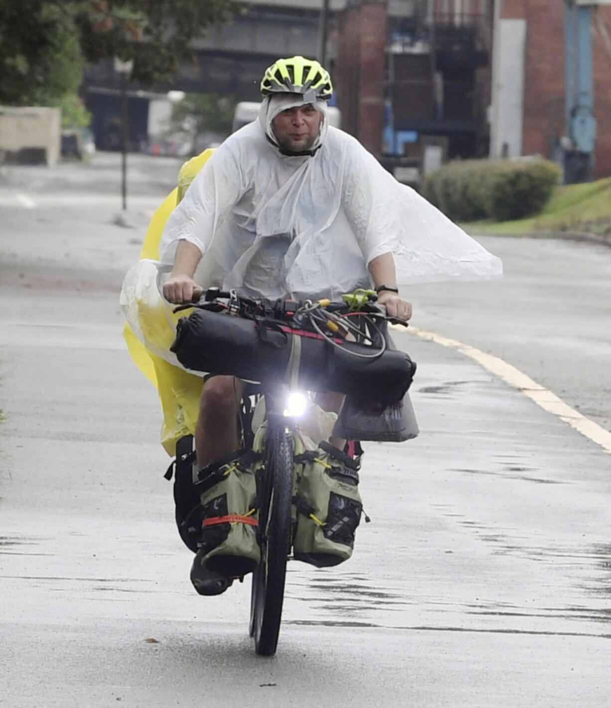 With the rain falling, a bicyclist dressed in wet weather gear travels along the Great Allegheny Passage near the McKeesport Hostel Tuesday, Aug. 31, 2021, in McKeesport, Pa.