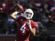 Washington State quarterback Jayden de Laura throws a pass during the first half of an NCAA college football game against Portland State, Saturday, Sept. 11, 2021, in Pullman, Wash.