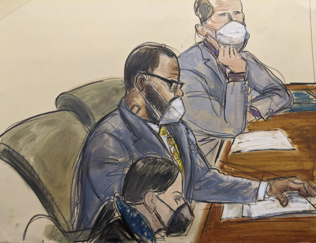 In this courtroom sketch, R. Kelly, center, sits with his defense attorneys Thomas Farinella, top, and Nicole Blank Becker during the first day of his defense in his sex trafficking case, Monday, Sept. 20, 2021, in New York.