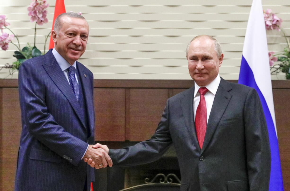 Russian President Vladimir Putin, right, and Turkish President Recep Tayyip Erdogan shake hands during their meeting in the Bocharov Ruchei residence in the Black Sea resort of Sochi, Russia, Wednesday, Sept. 29, 2021.