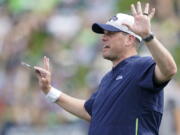 Seattle Seahawks offensive coordinator Shane Waldron calls to players during practice in Renton. Tasked with modernizing Seattle's offense and making Russell Wilson happy, Waldron's system finally gets its unveiling in the opener on Sunday against Indianapolis. (AP Photo/Ted S.