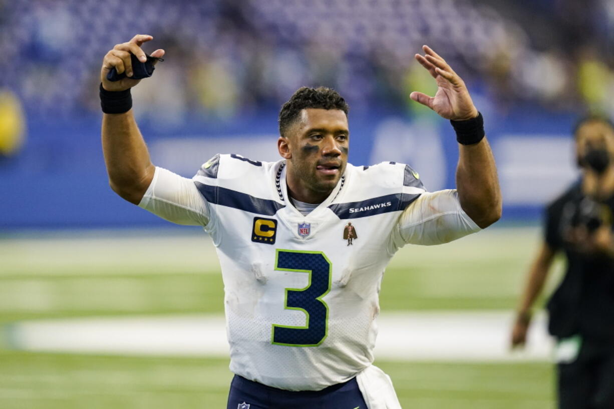 Seattle Seahawks quarterback Russell Wilson (3) waves to fans as he leaves the field following a 28-16 win over the Indianapolis Colts in an NFL football game in Indianapolis, Sunday, Sept. 12, 2021.