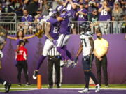 Minnesota Vikings tight end Tyler Conklin (83) celebrates with wide receiver Adam Thielen (19) after scoring a touchdown against the Seattle Seahawks in the first half of an NFL football game in Minneapolis, Sunday, Sept. 26, 2021.