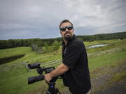 Korey Rowe uses his video camera near his home in Oneonta, N.Y. on Thursday, Aug. 12, 2021. Korey Rowe served tours in Iraq and Afghanistan and returned to the U.S. in 2004 traumatized and disillusioned. His experiences overseas and nagging questions about Sept. 11, 2001 convinced him America's leaders were lying about what happened that day and the wars that followed. (AP Photo/Robert Bumsted) (Ted S.