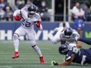 Tennessee Titans running back Derrick Henry (22) rushes against the Seattle Seahawks during the second half of an NFL football game, Sunday, Sept. 19, 2021, in Seattle.