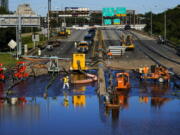 Workers pump water from a flooded section of Interstate 676 in Philadelphia Friday, Sept. 3, 2021 in the aftermath of downpours and high winds from the remnants of Hurricane Ida that hit the area.  The cleanup and mourning has continued as the Northeast U.S. recovers from record-breaking rainfall from the remnants of Hurricane Ida.