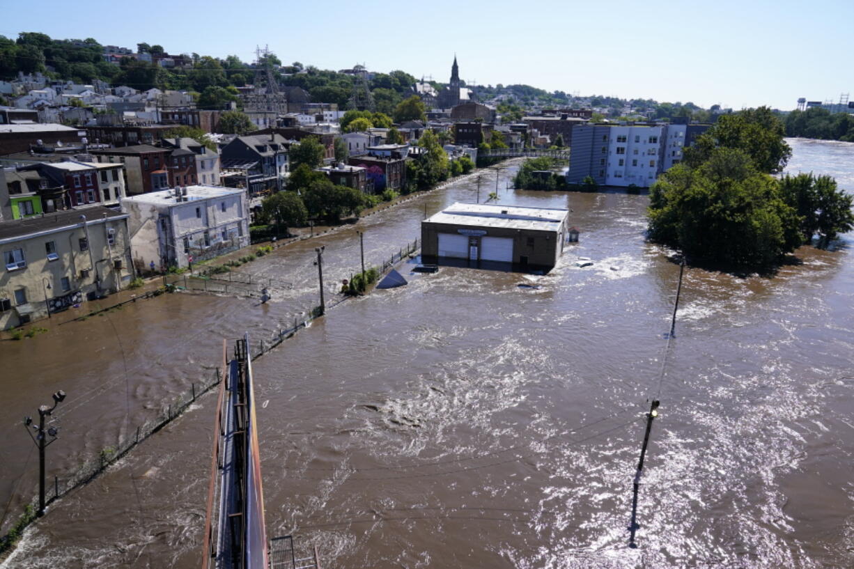 The Schuylkill River exceeds its bank in the Manayunk section of Philadelphia, Thursday, Sept. 2, 2021 in the aftermath of downpours and high winds from the remnants of Hurricane Ida that hit the area.