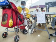 Viana Chacol, 65, and her dog, Chanel, rest at a cooling shelter at the Treme Recreation Community Center in New Orleans, La., Thursday, Sept. 2, 2021. The facility features water, charging stations, bathrooms, food, and other basic services to help residents after Hurricane Ida.