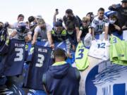 Fans attending most pro sporting events in Seattle will soon be required to show proof they've been vaccinated against COVID-19 or that they've tested negative for the virus. The NFL's Seahawks, MLS's Sounders, NHL's Kraken and the University of Washington all announced updated policies Tuesday, Sept. 7, 2021, for fans attending games this season.