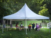 A class in Judaism is held under a tent set upon outside Temple Beth El, Monday, Aug. 30, 2021, in Augusta, Maine. The recent COVID-19 upsurge is disrupting plans for full-fledged in-person services. "The ability to see people face to face is wonderful, whatever way they choose to come," Rabbi Erica Asch says. "But there's a little bit of sadness that we can't all be together the way we'd like." (AP Photo/Robert F.