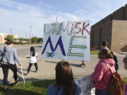 Protesters gather in front of Lakeshore High School, in Stevensville, Mich., Tuesday. Sept. 7, 2021, to protest recent COVID-19 mask mandates.