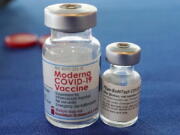 Vials of the Pfizer and Moderna COVID-19 vaccines (AP Photo/Rogelio V.