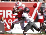 Utah running back TJ Pledger (5) runs for a touchdown as Washington State defensive back Jaylen Watson (0) tries to tackle him in the second half, of an NCAA college football game Saturday, Sept. 25, 2021, in Salt Lake City.