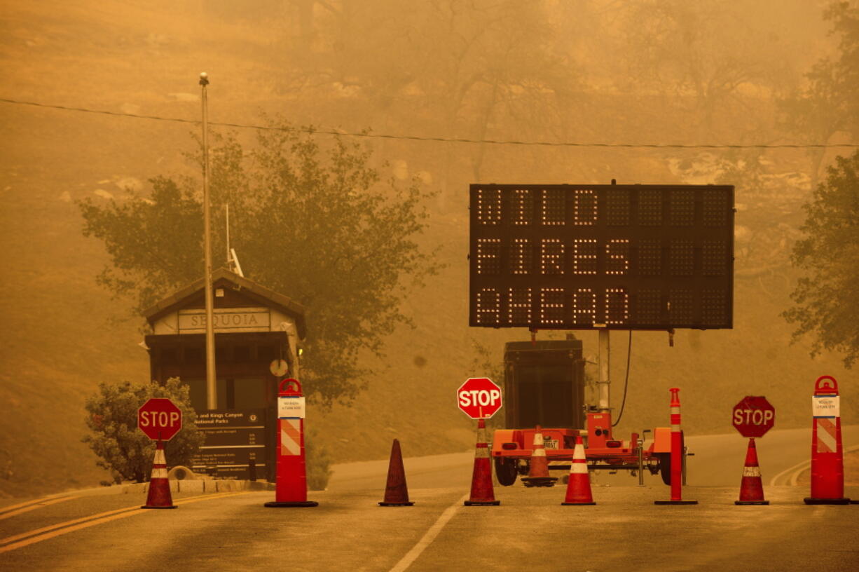 Cones block the entrance to Sequoia National Park, Calif., as the KNP Complex Fire burns nearby on Wednesday, Sept. 15, 2021. The blaze is burning near the Giant Forest, home to more than 2,000 giant sequoias.