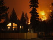 The Caldor Fire burns near homes near South Lake Tahoe, Calif., Wednesday, Sept. 1, 2021. (AP Photo/Jae C.