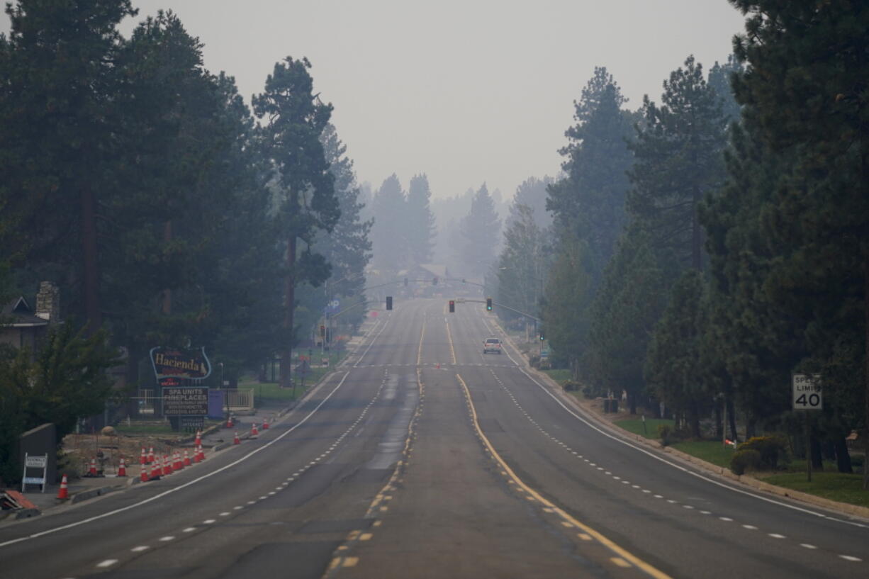 A truck drives along Highway 50 in South Lake Tahoe, Calif., Thursday, Sept. 2, 2021. Better weather on Thursday helped the battle against a huge California forest fire threatening communities around Lake Tahoe, but commanders warned firefighters to keep their guard up against continuing dangers. (AP Photo/Jae C.