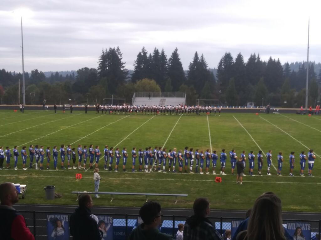 Kalama and La Center players line up for the national anthem before their game on Friday Sept.