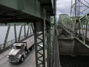 A truck driver travels north on the Interstate Bridge.