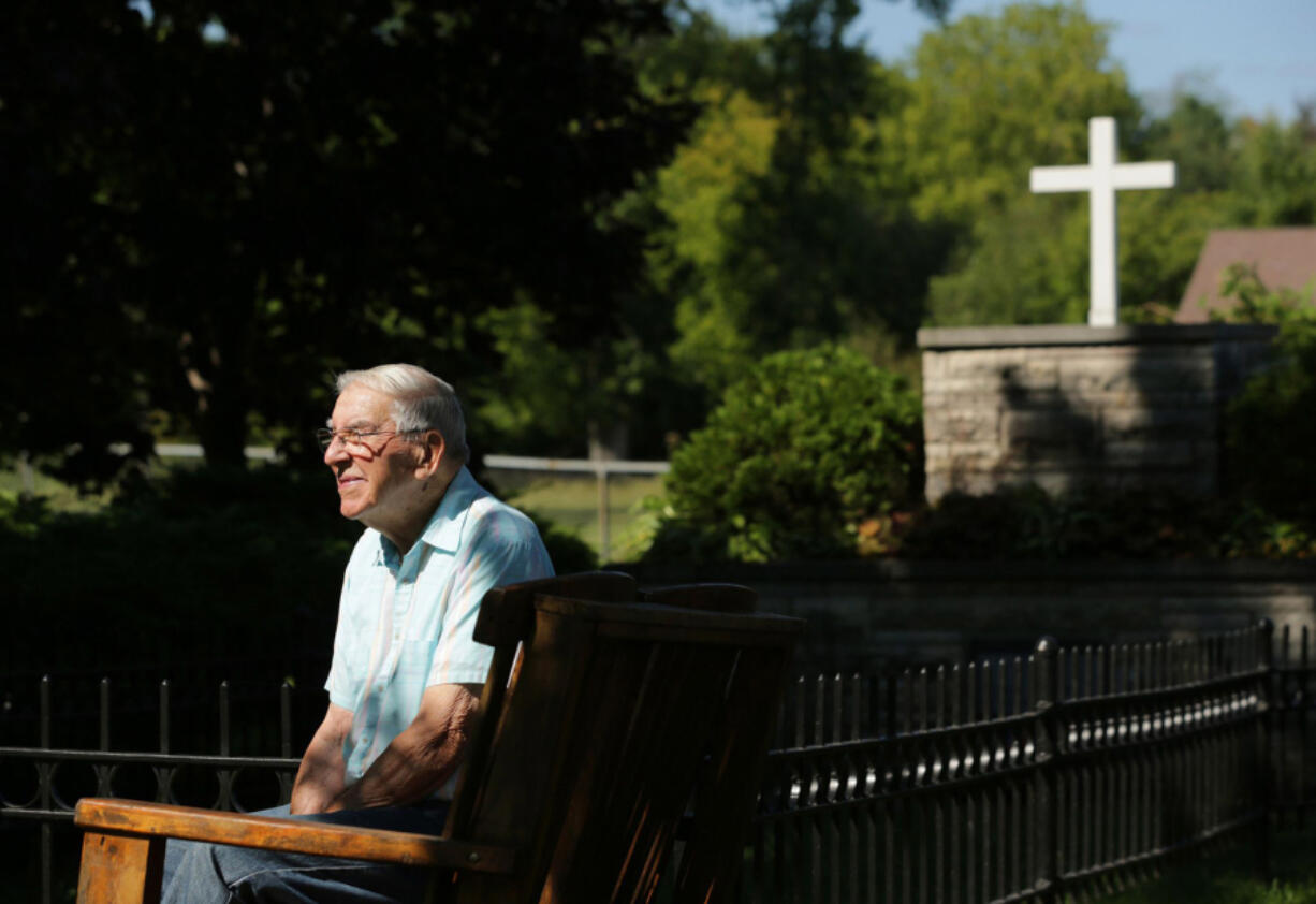 A portrait of Cubby Couvillion, 95, sits near the mass grave in the Peshtigo Fire Cemetery on Sept. 1, 2021, in Peshtigo, Wisconsin.