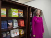 Susan Stearns stands near the book bank at Pink Lemonade Project's downtown Vancouver offices. She took over as CEO of the nonprofit as the pandemic hit in March 2020 and has guided an expansion of programs. Participation increased 30 percent during the pandemic.