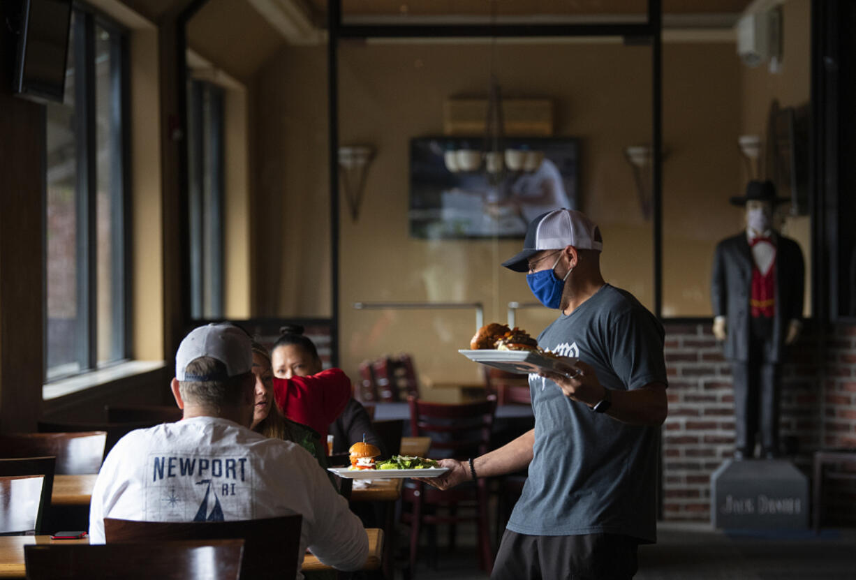 Bartender Mike Dunning serves lunch in the dining room at Main Event East in late 2021.