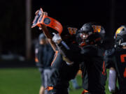 Washougal's Garrett Mansfield lifts the turnover belt after recovering a fumble in a 2A Greater St. Helens League football game on Friday, Oct. 1, 2021, at Fishback Stadium in Washougal. Ridgefield won 39-13.