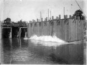 This concrete box allowed workers access to the floor of the Columbia River to anchor and build the bridge piers holding up the Portland-Vancouver railway bridge connecting Oregon and Washington. This 1906 photo shows the caisson (box) being lowered into the river. About two years later, regularly scheduled trains crossed the two-rail bridge daily in both directions, north and southbound.