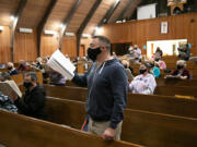 Ryan Allen, a longtime member of the Vancouver Master Chorale, focuses on the music Monday while wearing a face mask specifically designed for singing during a recent rehearsal at First Presbyterian Church. "It feels very different," Allen said.