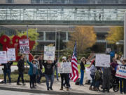 Medical staff placed on administrative leave and those against a vaccination mandate gather during a protest outside Legacy Salmon Creek Medical Center on Friday afternoon. According to Legacy, 794 unvaccinated employees were placed on leave beginning Friday.