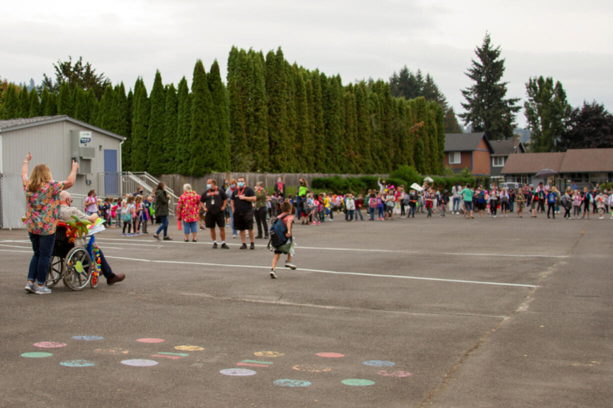 Woodland: Students and staff at North Fork Elementary School celebrate head custodian Ed Sorensen's retirement with a celebration tunnel.