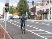 A cyclist rides south on Columbia Street bike lane, a part of the Westside Bike Mobility Project that aims to improve safety for bikers and pedestrians traveling through the city.