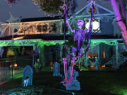 A laughing skeleton sits on a swing at the Mains' house on Franklin Street in Vancouver.