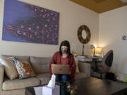 Kendall Hagensen of The Vancouver Wellness Studio is pictured in her office while looking over her laptop. "We're seeing collective trauma," she said about workers in the pandemic.