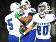 Mountain View senior CJ Hamblin (6) celebrates with teammates after making an interception Friday against Prairie in the 3A Greater St. Helens League game at District Stadium in Battle Ground. The Thunder won 17-14.