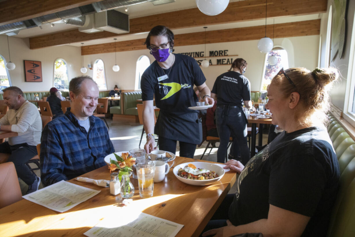 Nicole Kluka serves breakfast to Brian and Leah Trudell at The Diner Vancouver. As fans of diners and midcentury style, the Trudells were excited for their first visit.