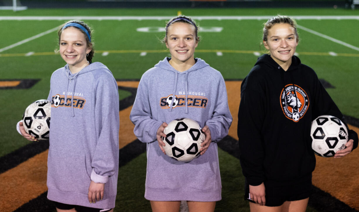 From left, Molly, Emily and Lauren Rabus pose for a portrait after a practice on Monday, Oct. 18, 2021, at Washougal High School.