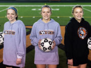 From left, Molly, Emily and Lauren Rabus pose for a portrait after a practice on Monday, Oct. 18, 2021, at Washougal High School.