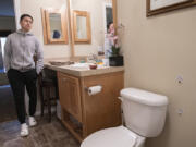 Lorenz Soriano of Vancouver looks over three bullet holes, right, in his bathroom Monday afternoon after Clark County sheriff's deputies fired at a suspect Sunday morning that the agency said was armed with a handgun.